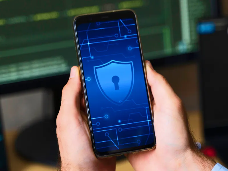 Man holding his phone while looking at a screen of locks